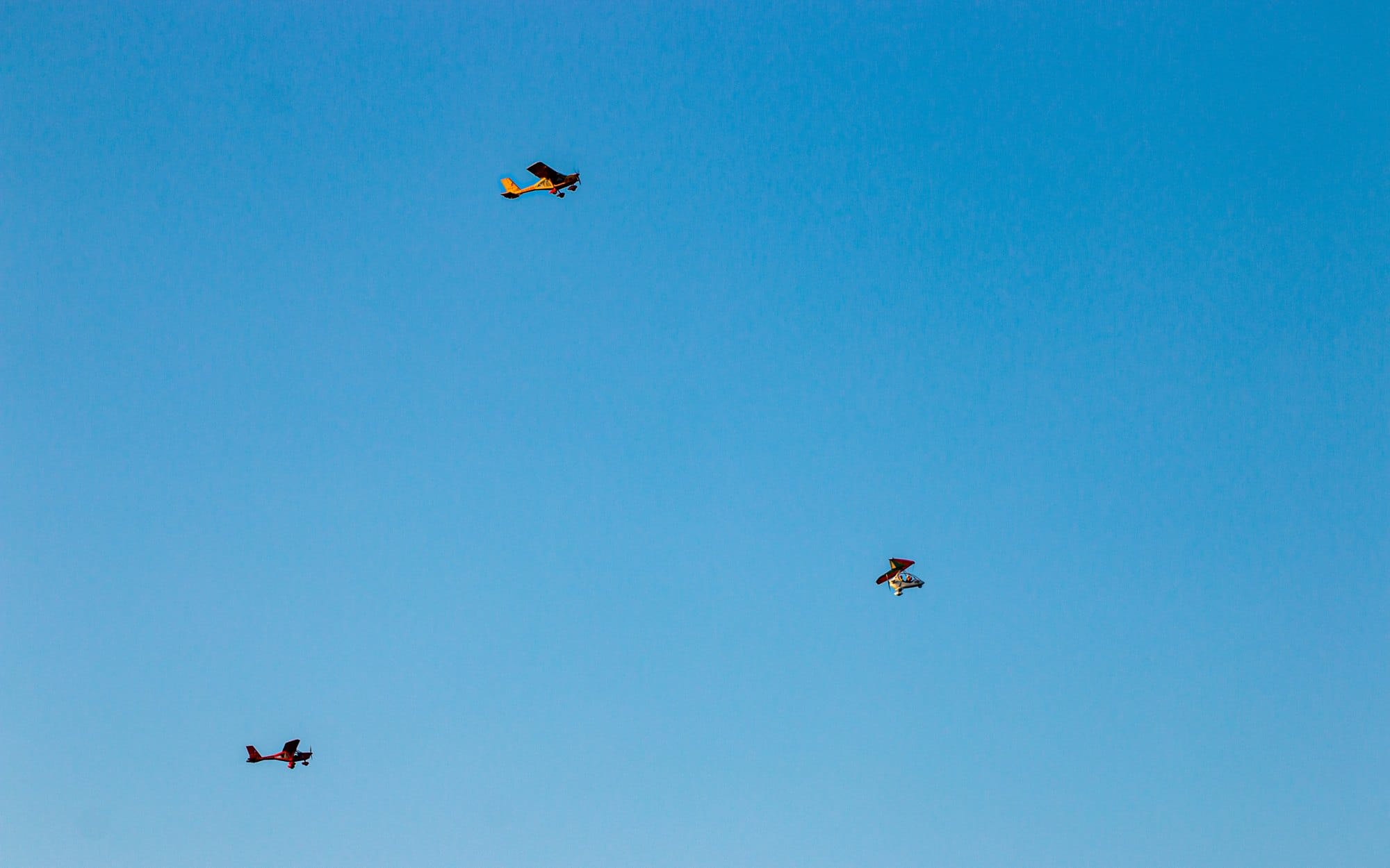 Planes flying in a clear blue sunny sky