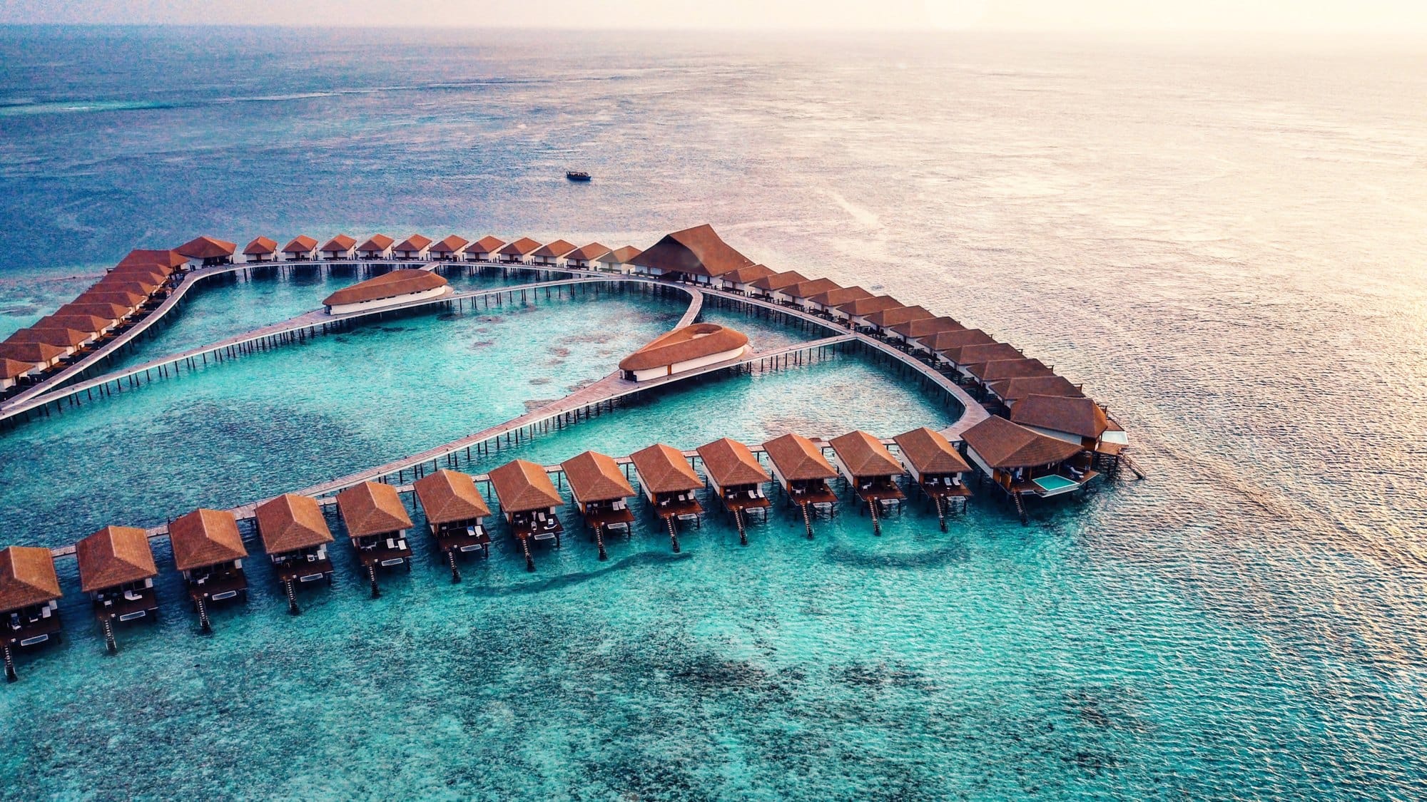 Scenic View of Overwater Bungalows in Tropical Sea