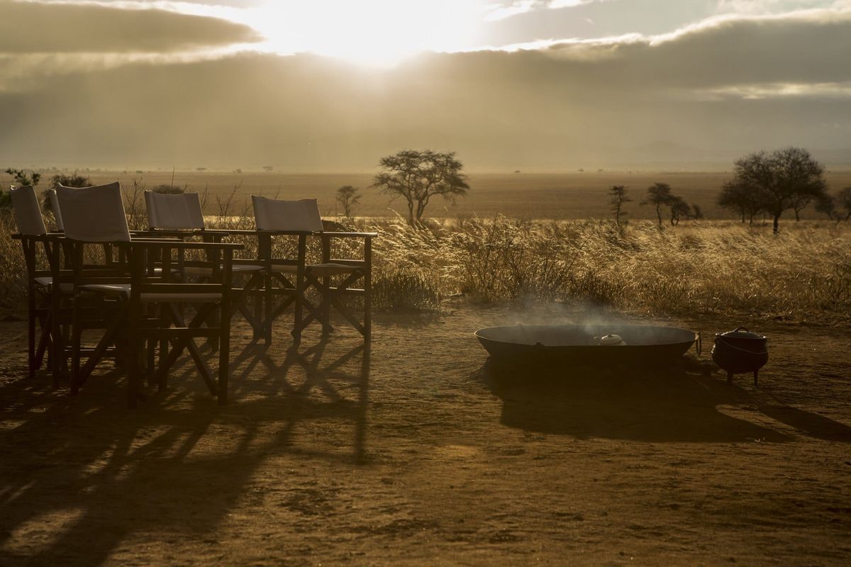 Serene Landscape with Chairs and Fire Pit at Sunset