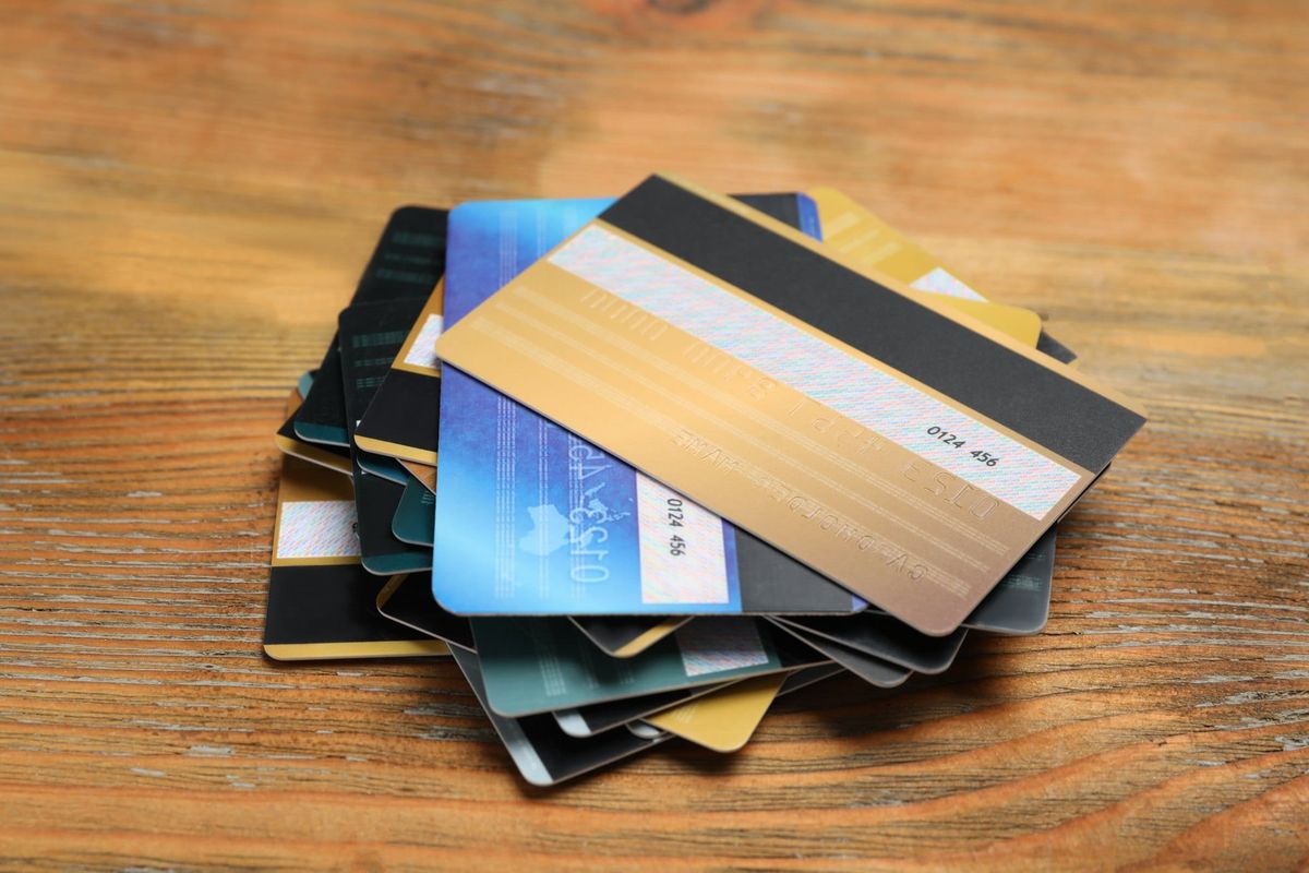 Pile of Credit Cards on a Wood Surface