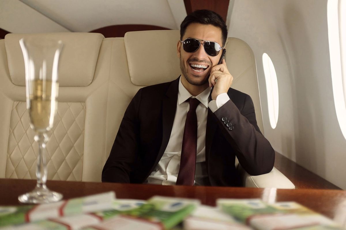Man in Private Jet Talking on Smartphone
