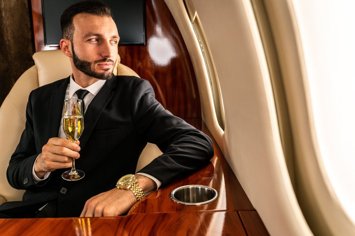 Elegant Man with Champagne on Private Plane