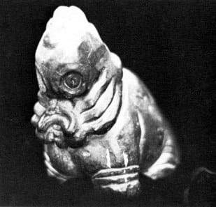 Statuette of a horrid monster with folds of flesh hanging off its face