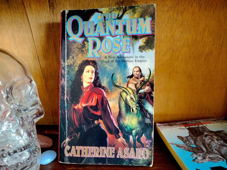 A woman in a red silk blouse looks uncertainly at a man in a fur cloak, riding a green alien horse