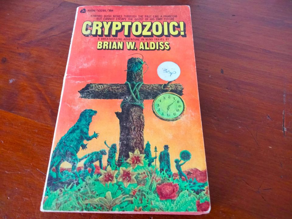 dinosaurs and humans marching beneath a huge wooden crucifix with a pocketwatch hanging off it.