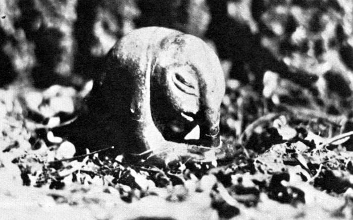 Statuette of an inhuman figure with slitted eyes and a drooping nose