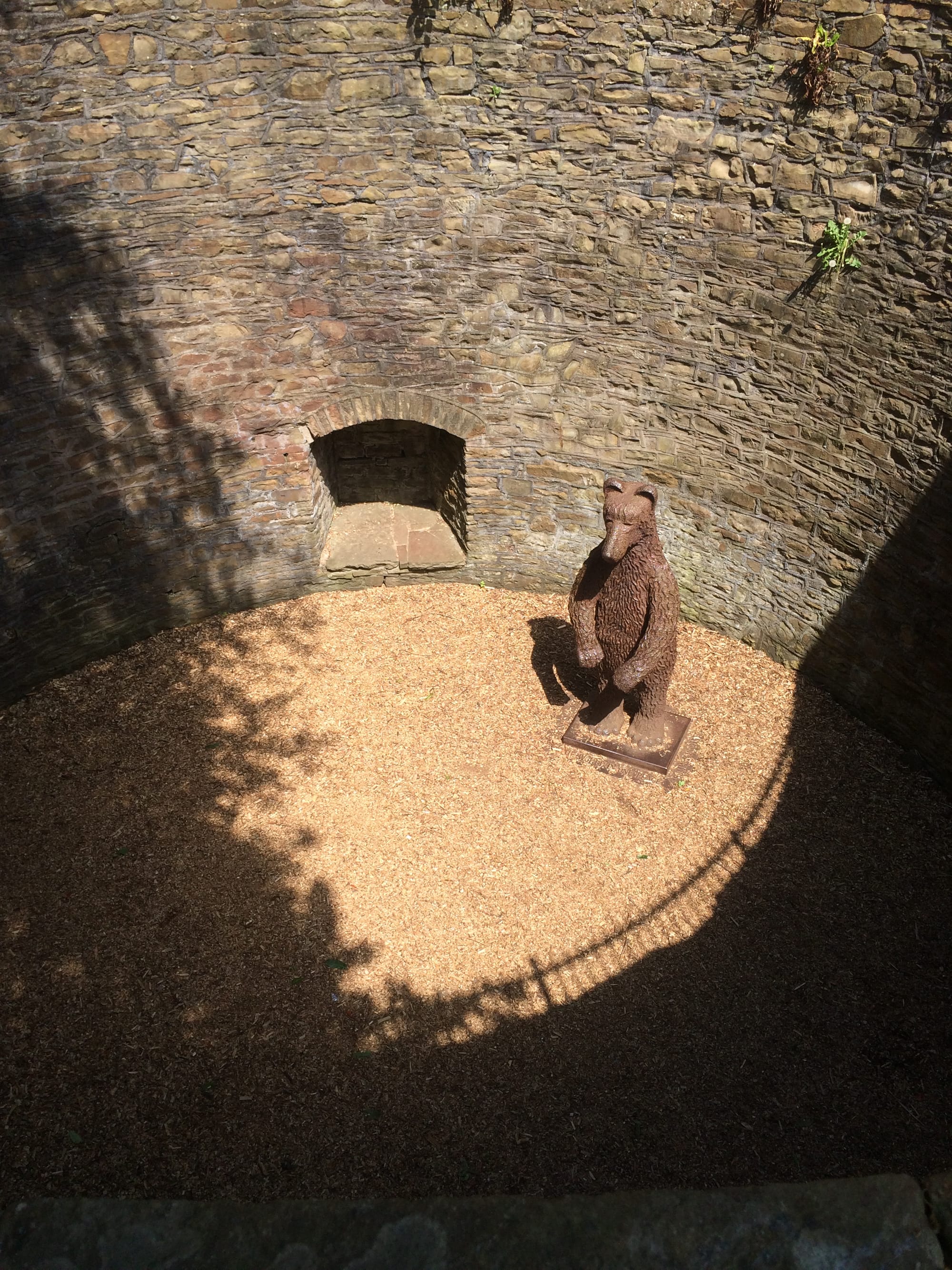Historical bear pit at Sheffield Botanical Gardens in England, now containing a statue