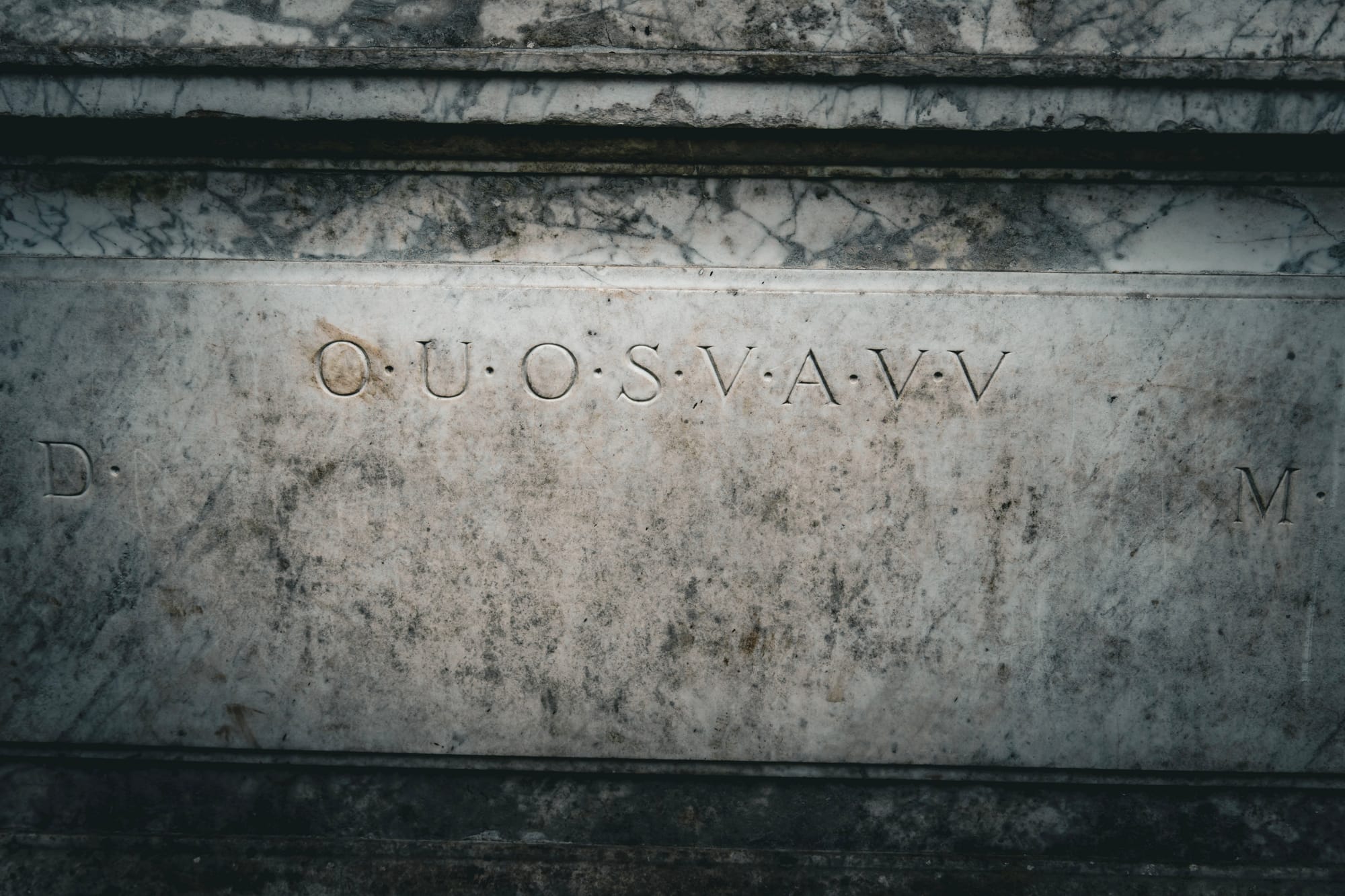 The Shugborough Inscription itself: O U O S V A V V, with D and M beneath, carved into the plaque below the marble relief and undeciphered since the 18th century. Photo: Jenna Goodwin / The Red Haired Stokie