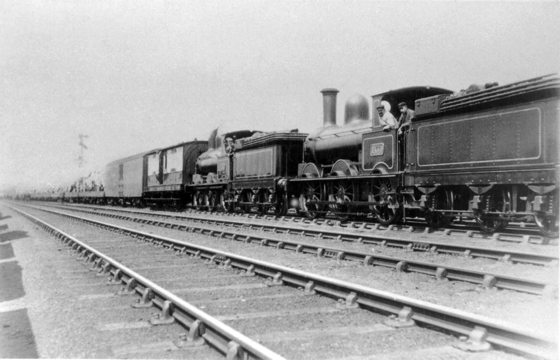 Barnum and Bailey circus train hauled by two locomotives with flat cars