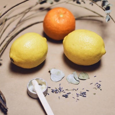yellow lemon fruit beside silver fork on white and blue floral textile