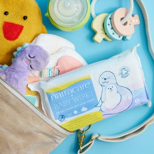 A diaper bag filled with baby items and a stuffed animal