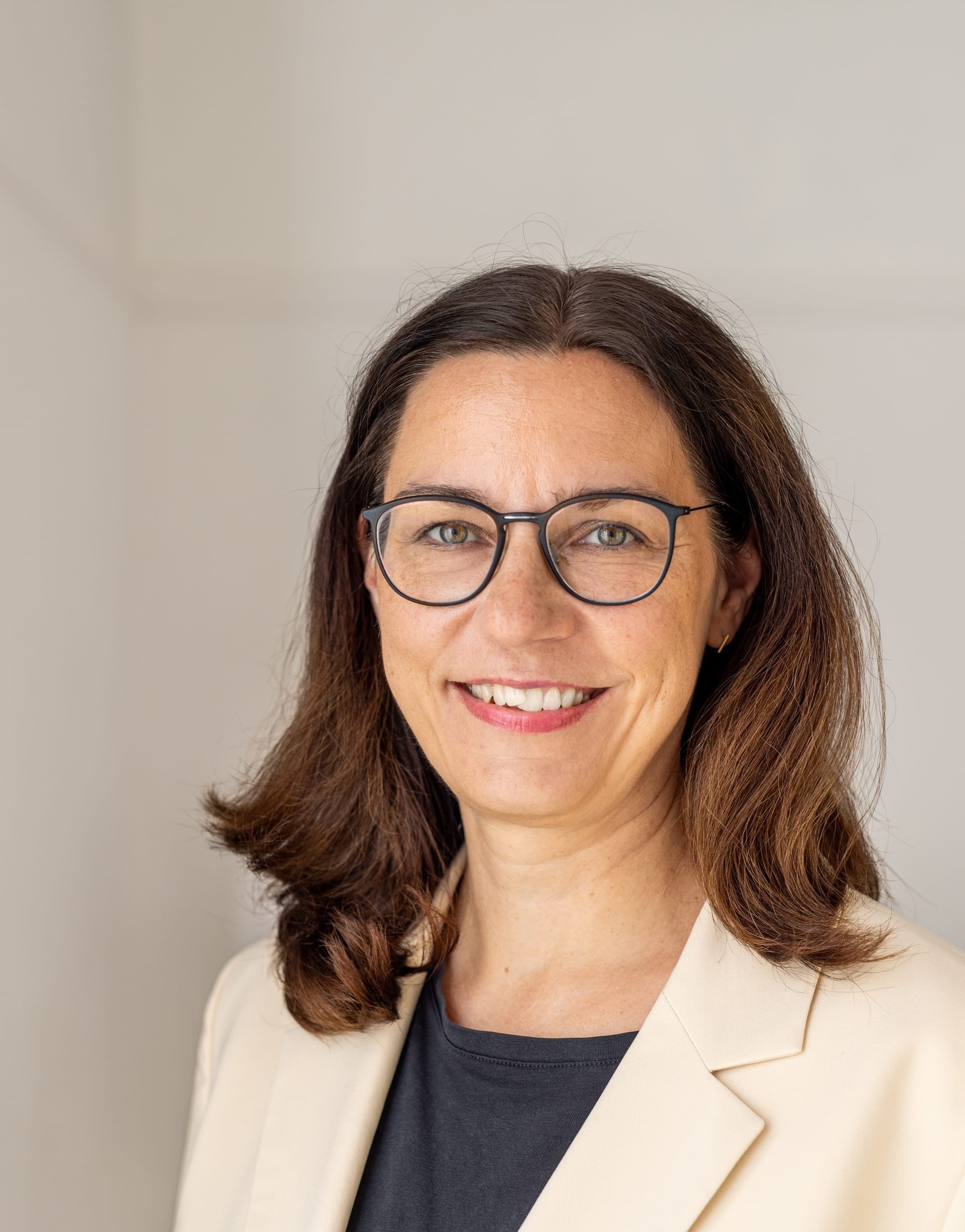 Profilbild von Anne-Katrin Neyer vor einer hellen Wand.