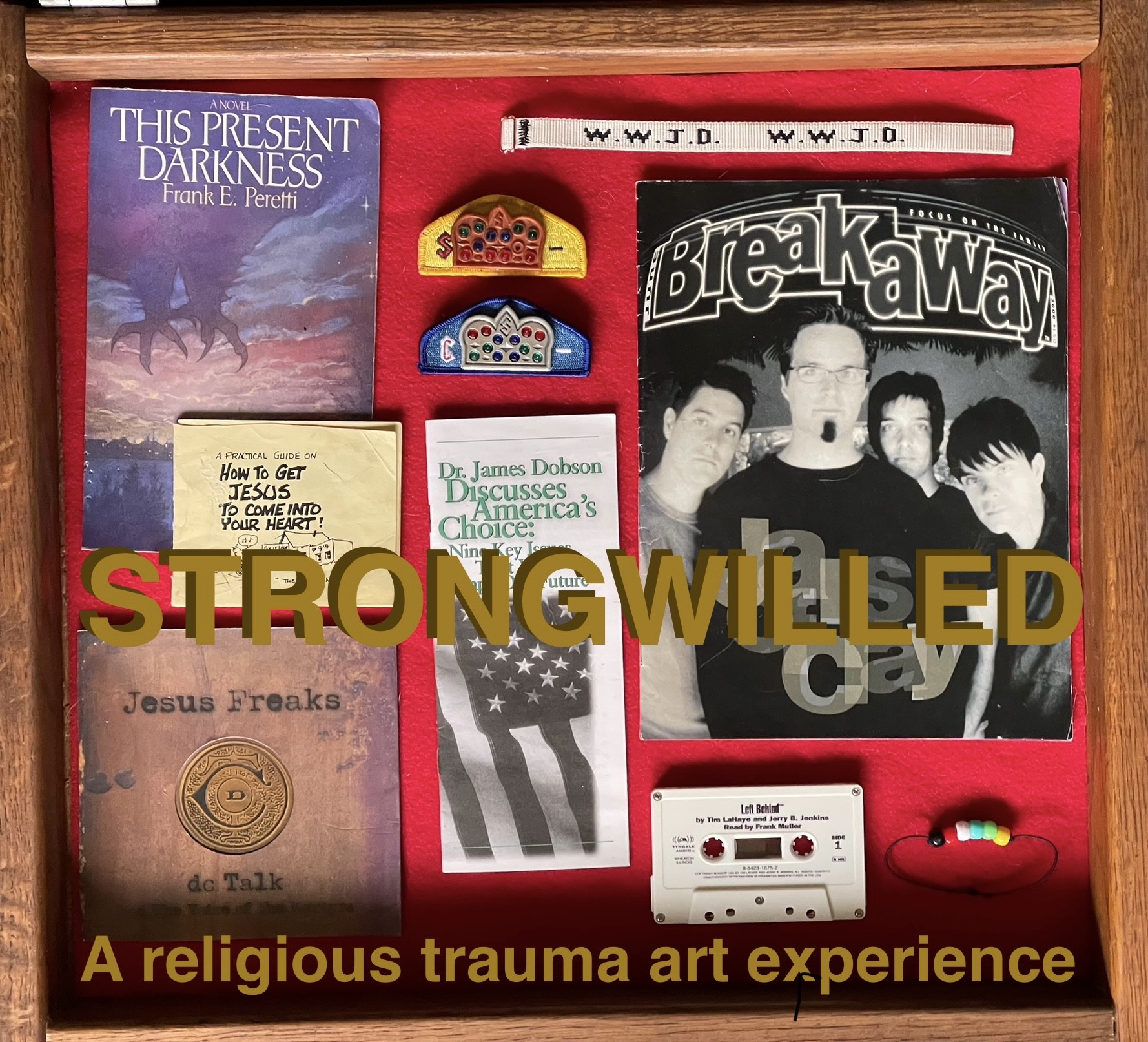 a wooden box with a red background has an assortment of evangelical artifacts on it like wwjd bracelets, a jesus freaks album, this present darkness by frank peretti, and more. text says strongwilled a religious trauma art experience
