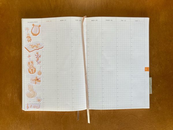 A Haroo Planner weekly view open to November 26 - December 1. A bunch of music-themed stickers decorate the left side of the page. A beige ribbon lays down the center as a bookmark.