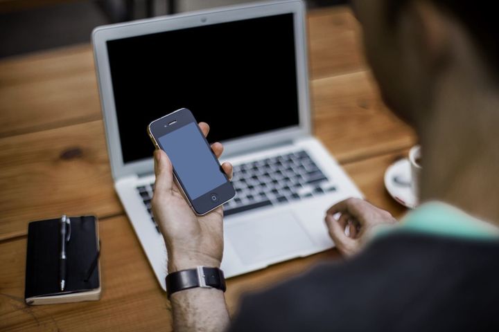 Human reading a smartphone