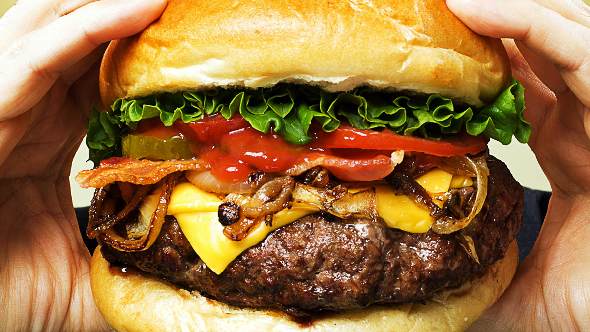 Close up of man eating hamburger, seen from his last bite.
