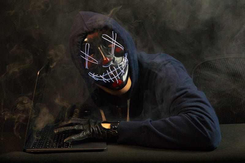 A masked hacker at a keyboard.