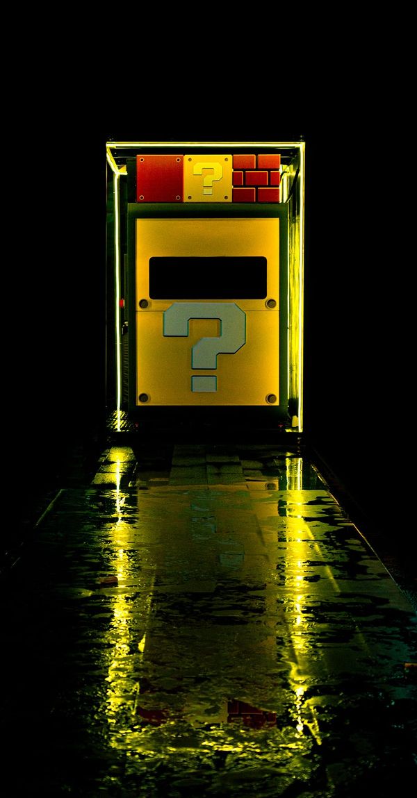 Super Mario video game booth with question marks.