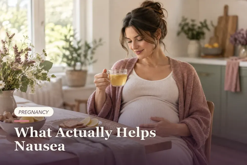 A pregnant woman resting with ginger tea, crackers and lemon.