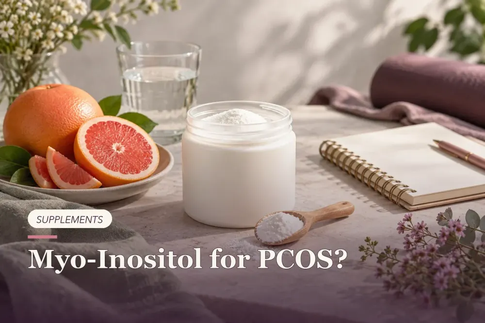 Myo-inositol powder beside an unbranded jar, citrus and a blank journal.