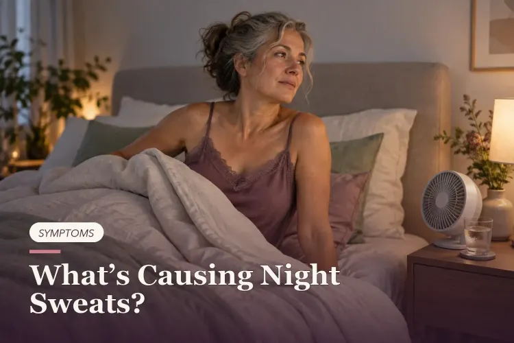A midlife woman sitting up in bed beside a fan and water.