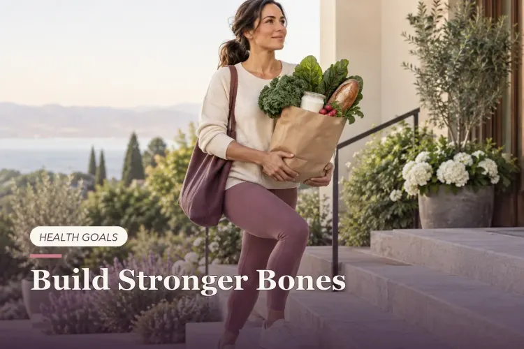 A woman carrying yogurt and leafy greens while stepping upward.