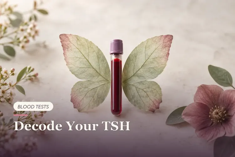 A blood sample tube beside two leaves arranged in a butterfly shape.