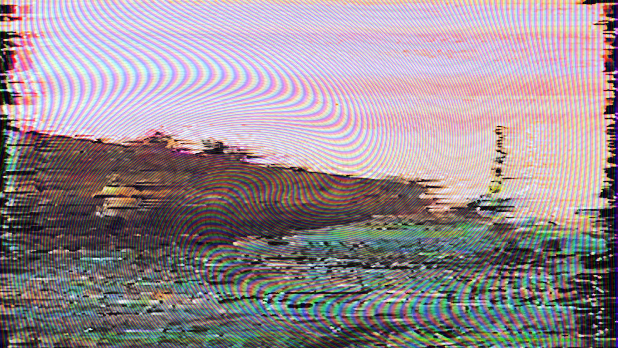 An image of a coastline obscured by effects giving it an analogue video quality
