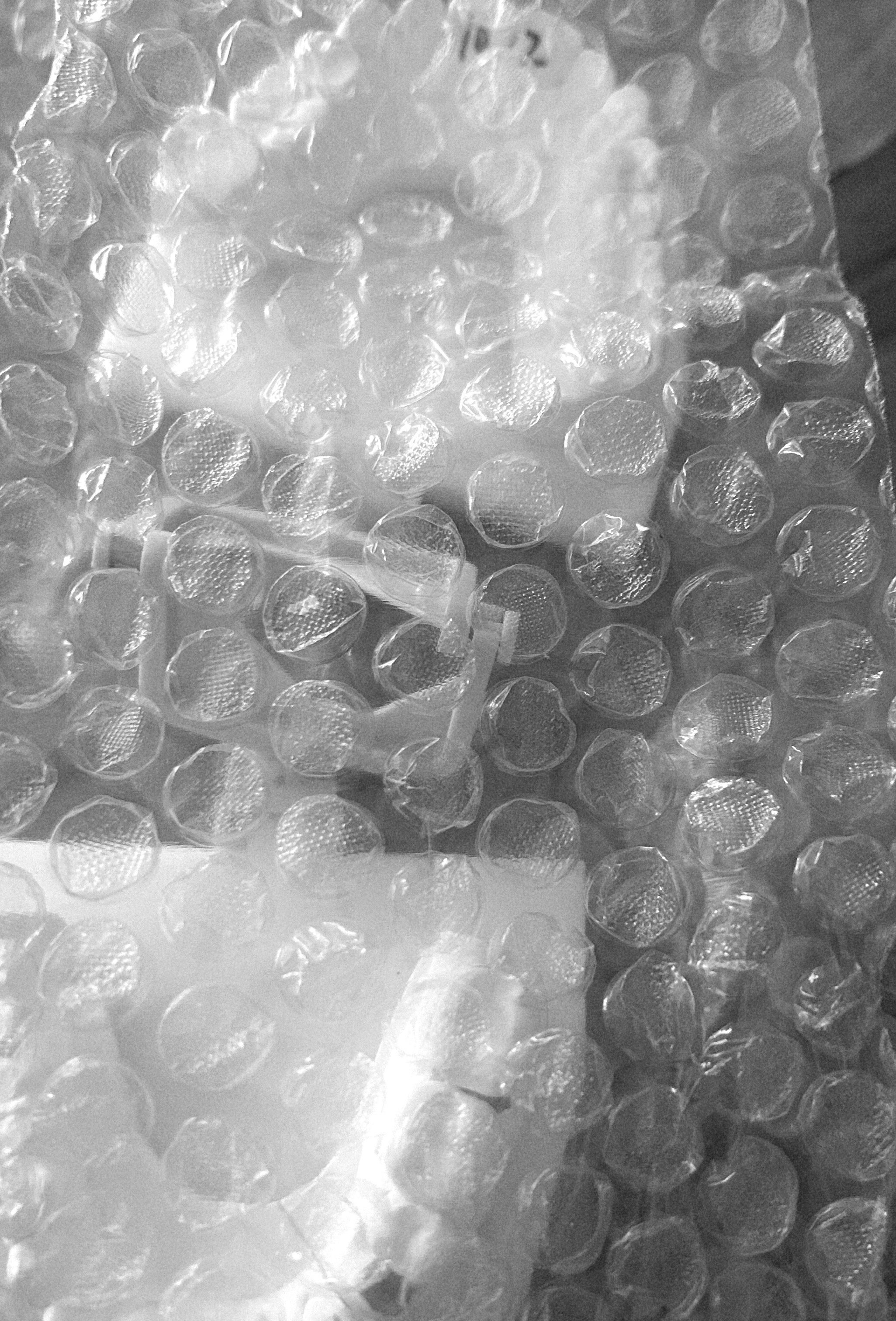 A bubble wrap with a couple of white objects

Description automatically generated