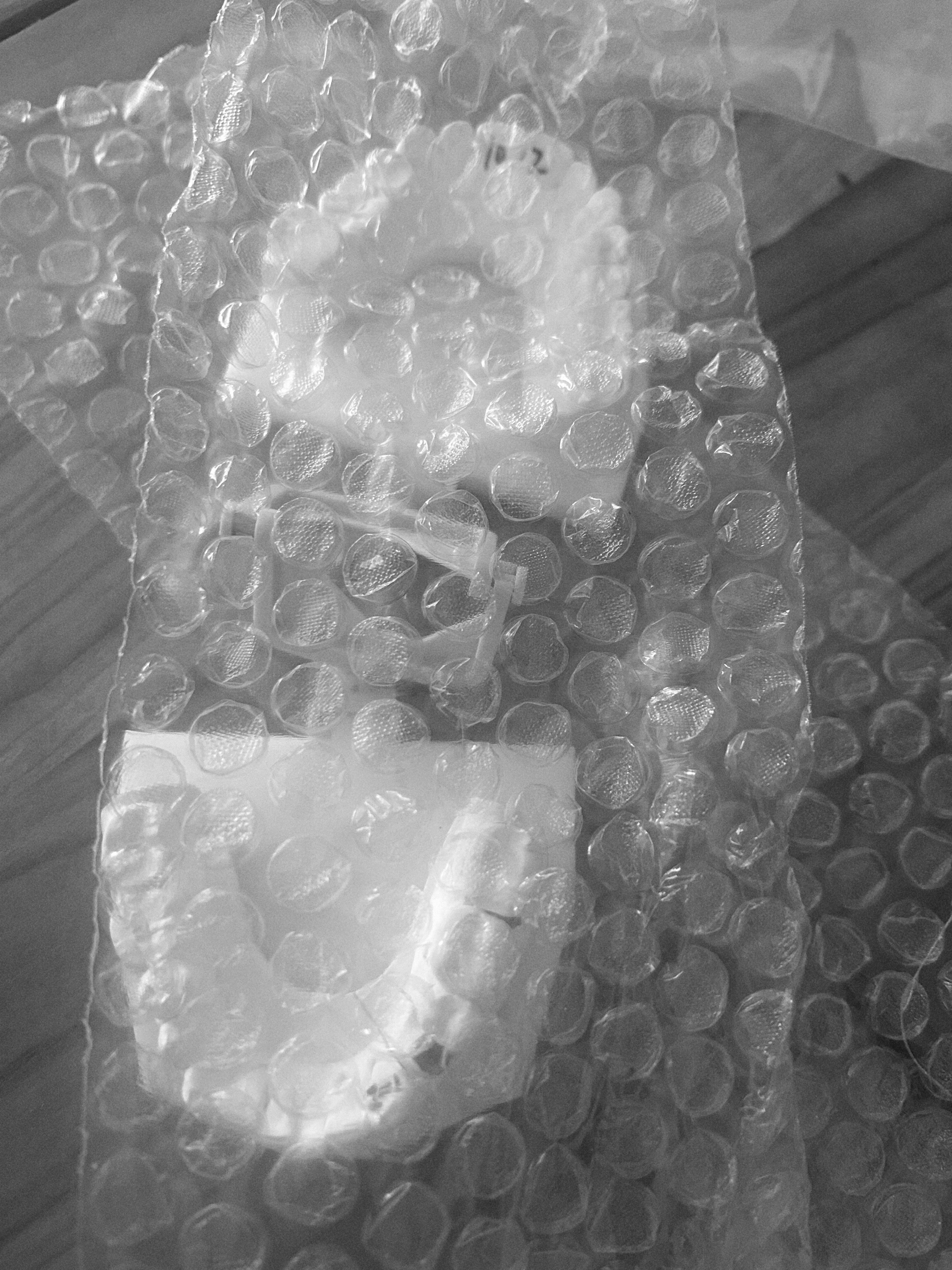 A bubble wrap with a couple of white objects

Description automatically generated
