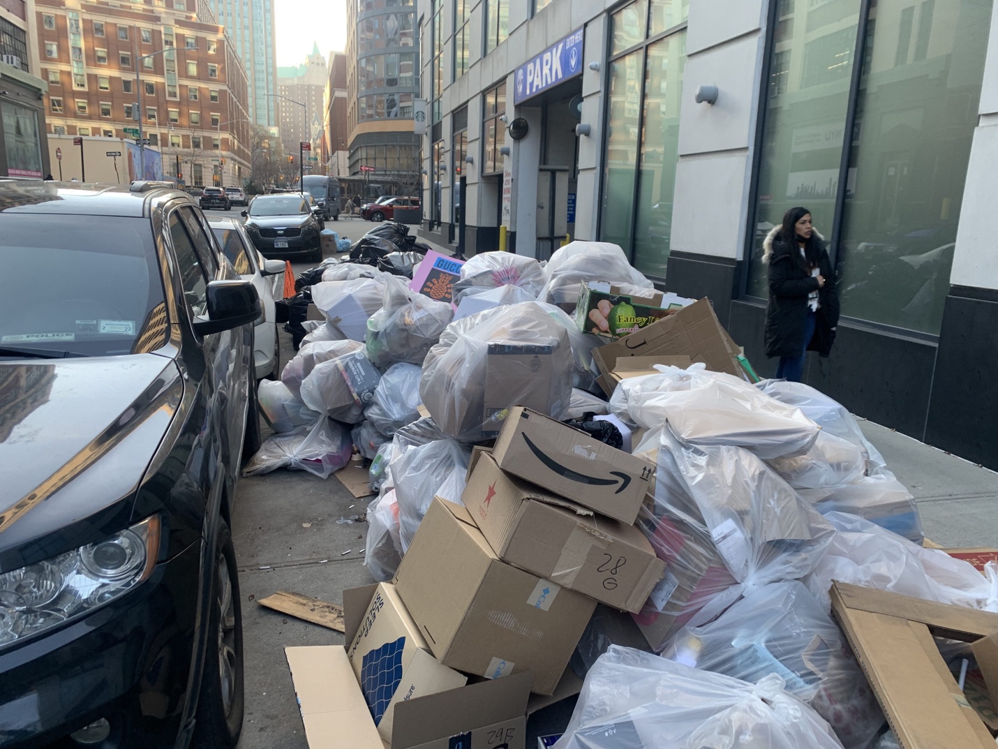 A pile of garbage on the side of a street

Description automatically generated