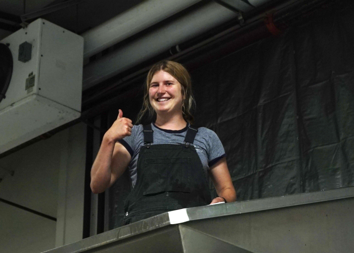 Harvest Intern Louisa Cleaning the Press
