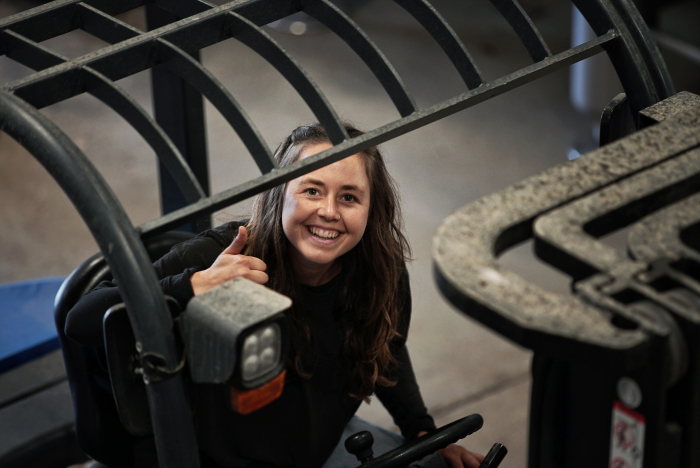 Kayja Mann on a forklift at Tablas Creek