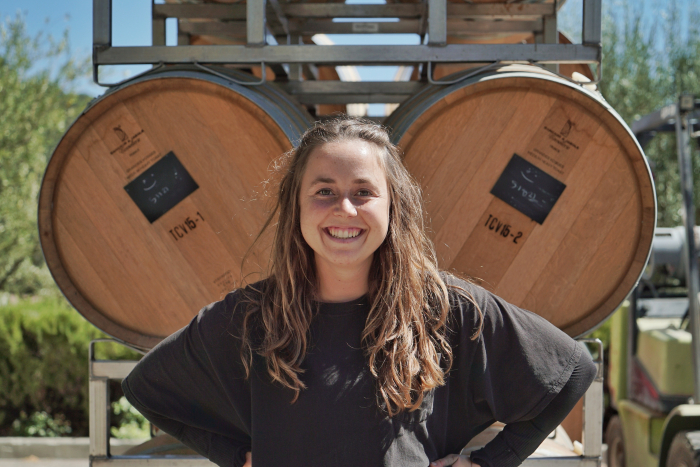 Kayja Mann in front of barrels at Tablas Creek