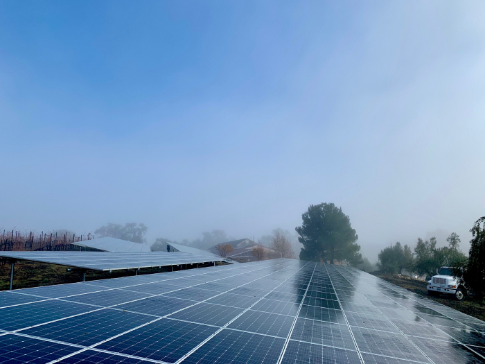 Solar panels vineyard truck and blue sky
