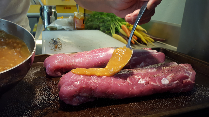 Spooning glaze on meat