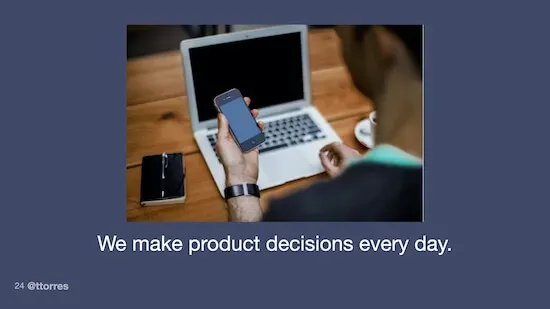 A photo of a person sitting at a desk holding a smartphone and looking at a laptop computer. The caption on the photo reads, "We make product decisions every day."