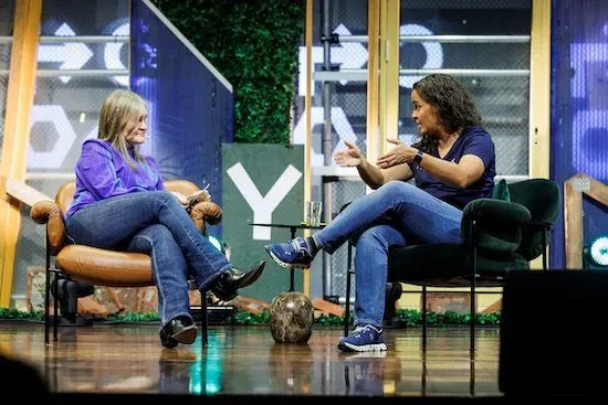 A photograph of Teresa and the Y Oslo host during the fireside chat. They are both sitting in chairs and talking to each other.