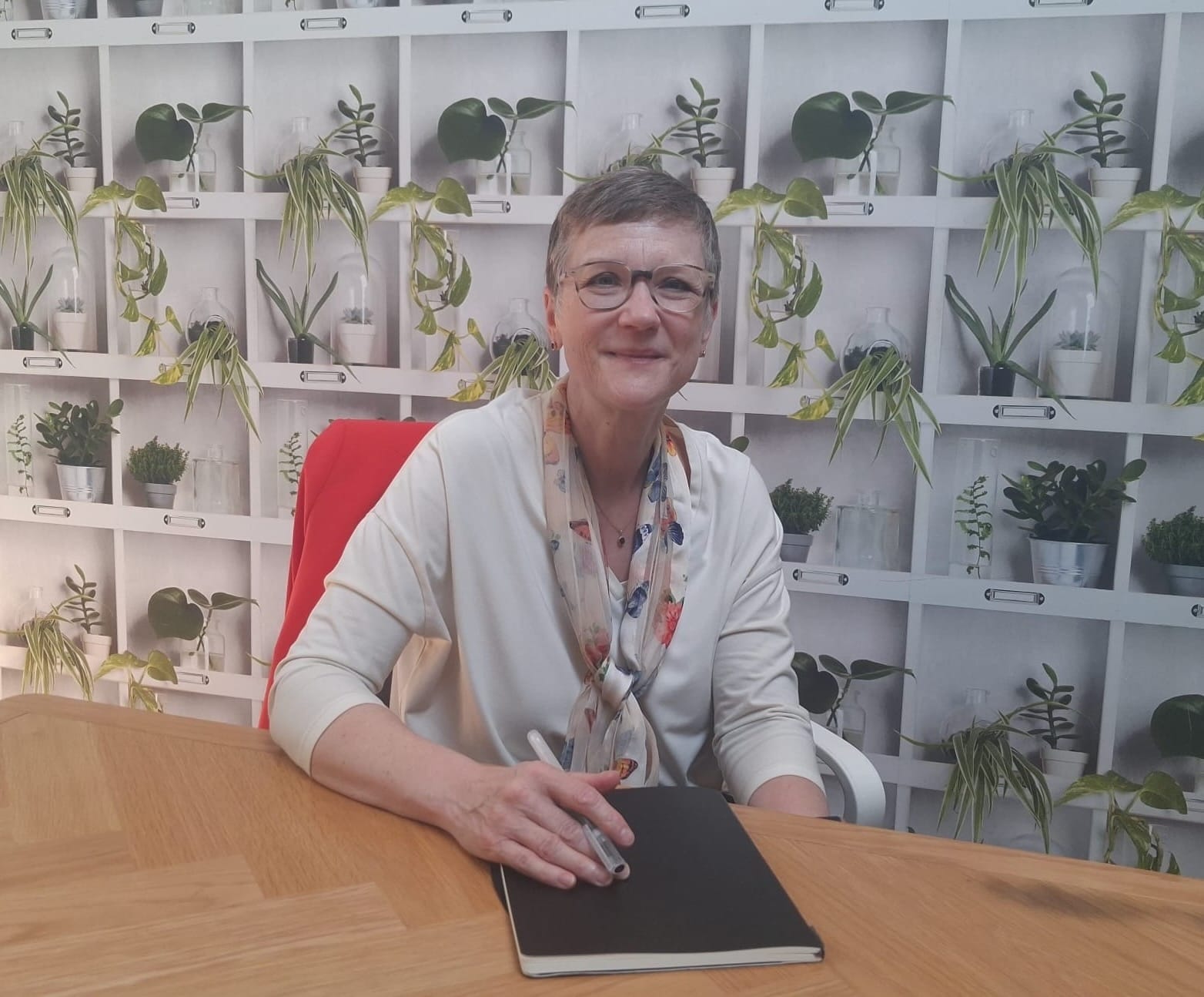 Lucy Caldicott, founder of ChangeOut, sitting at a table with a notebook