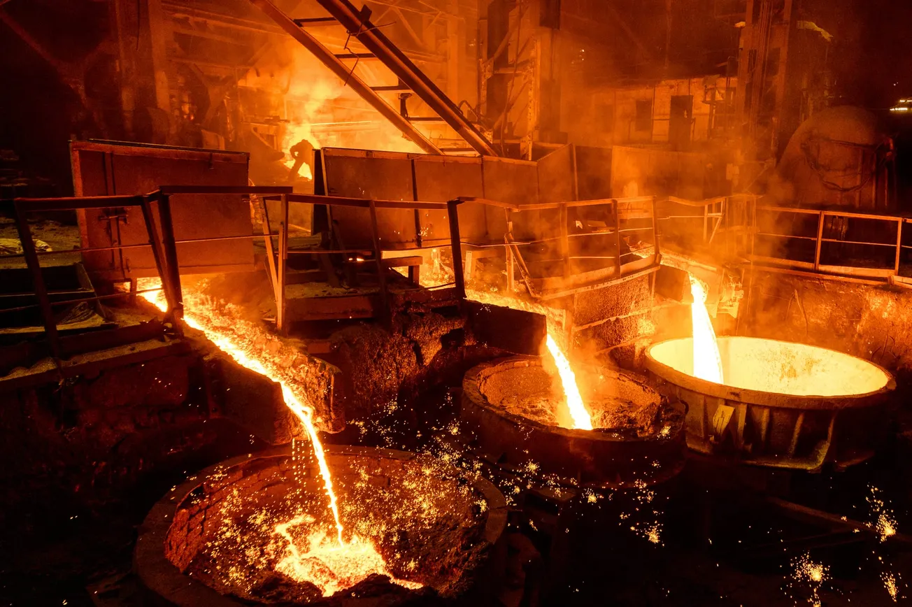 Blast furnace slag and pig iron tapping. Molten metal and slag are poured into a ladle. Metallurgical industry.