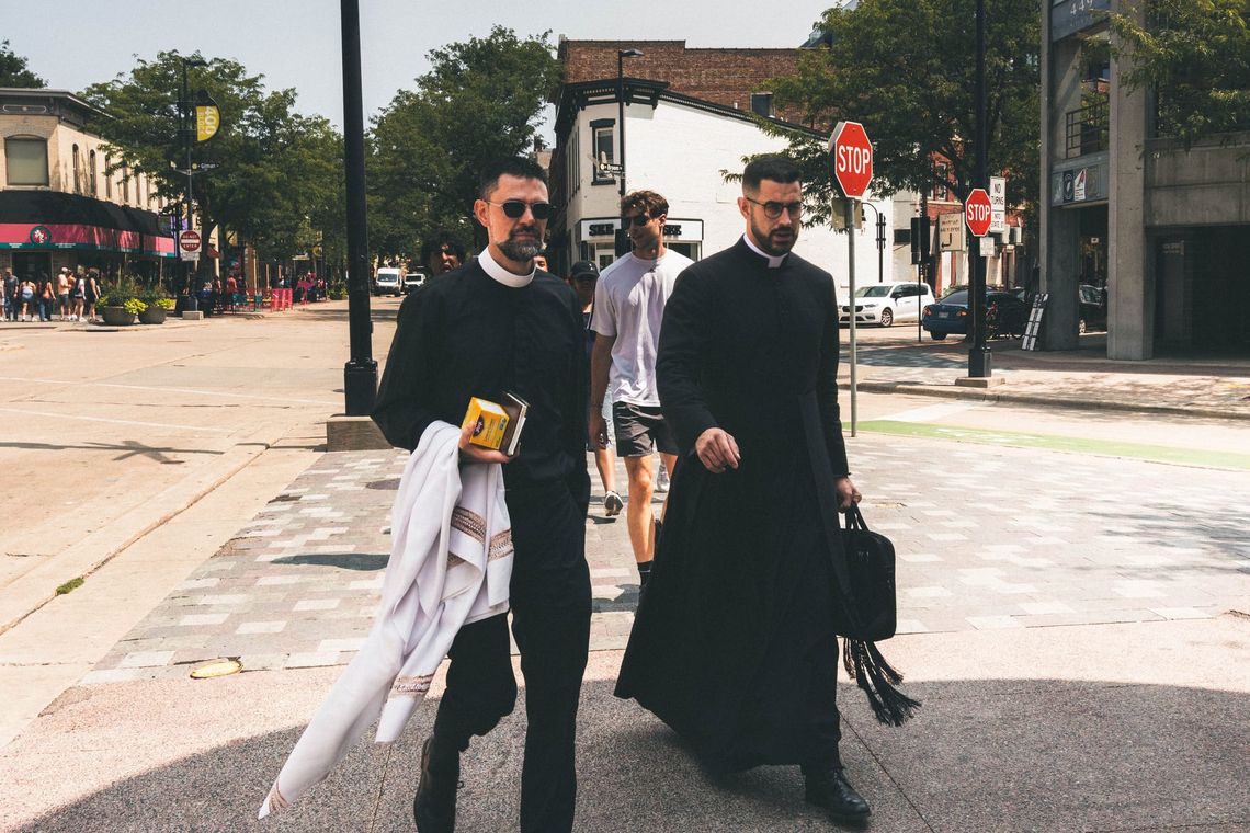 "Two Priests, Walking Briskly"