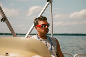 "Man Driving Boat, Serious"
