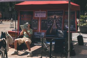 "Man Sitting on Bench, Reading"
