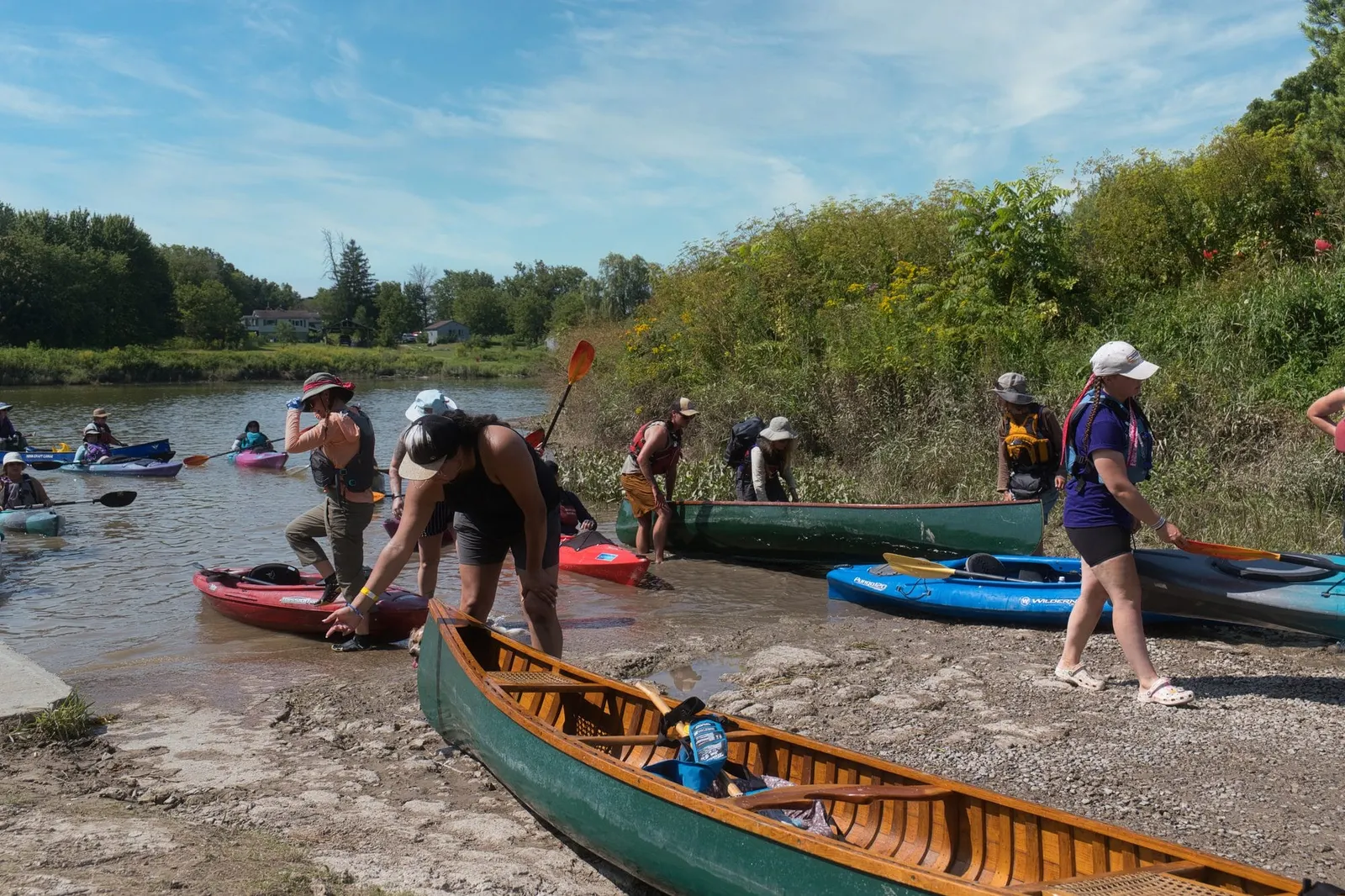 Canoes and kayaks along the banks of the Grand River