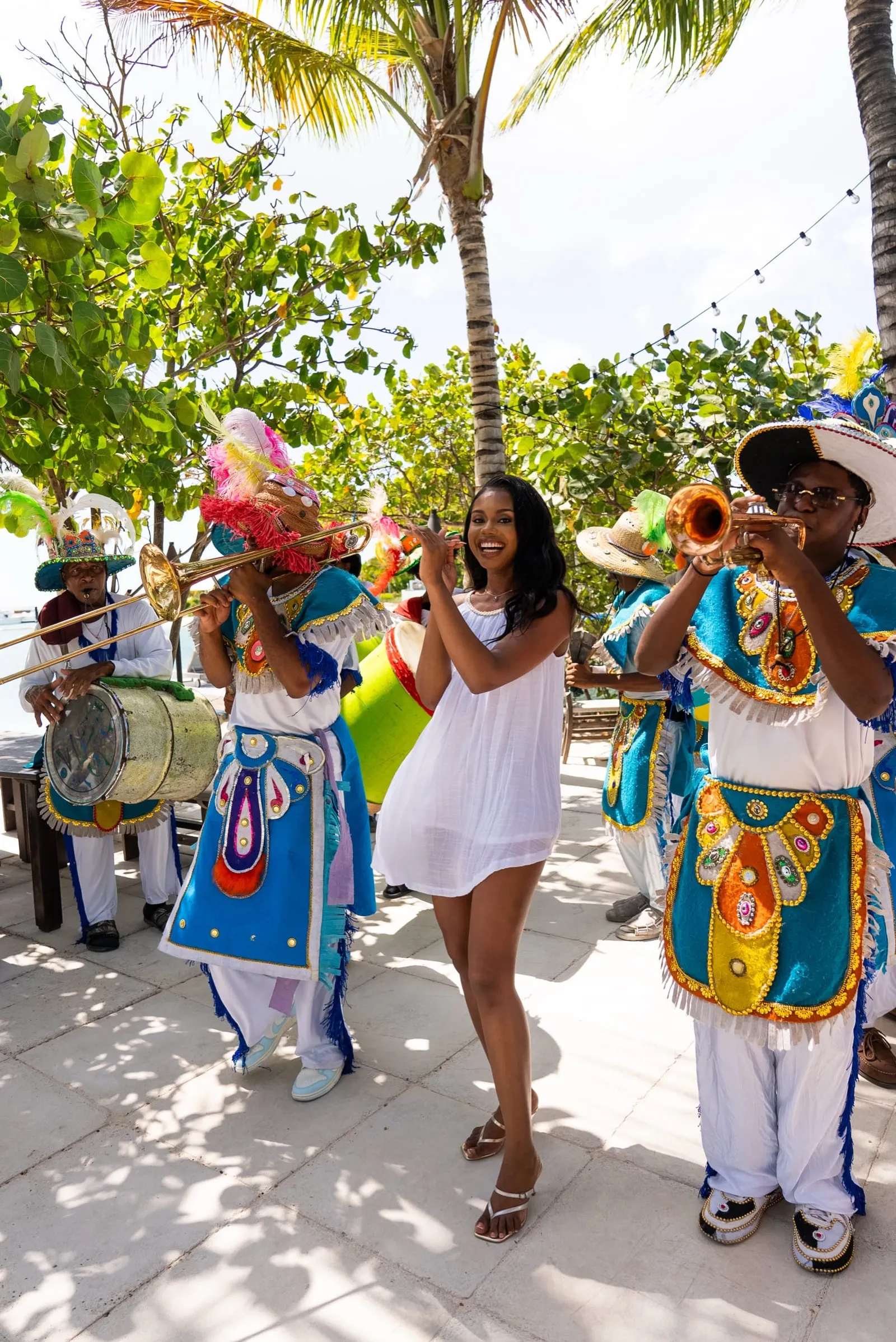 Dancers in bright costumes and musicians performing at an outdoor street festival