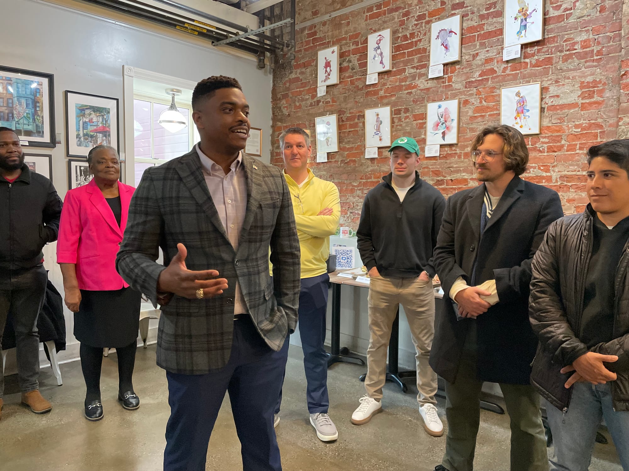 Cafe Ula co-owner Marvin Mathelier, who is running for an at-large seat on the City Council, addresses supporters gathered at Cafe Ula.