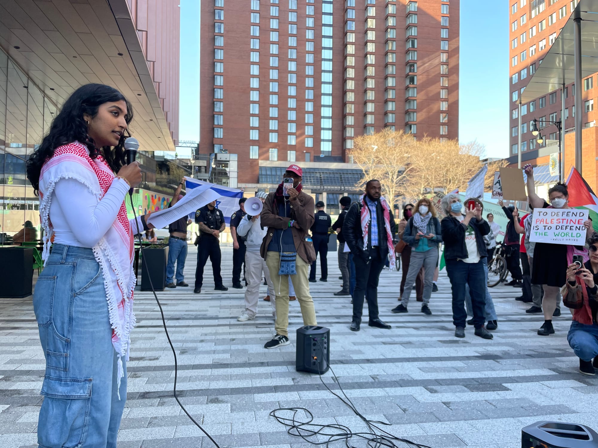 MIT student Megha Vemuri speaks in front of a gathering of demonstrators in front of the MIT Museum in Cambridge.