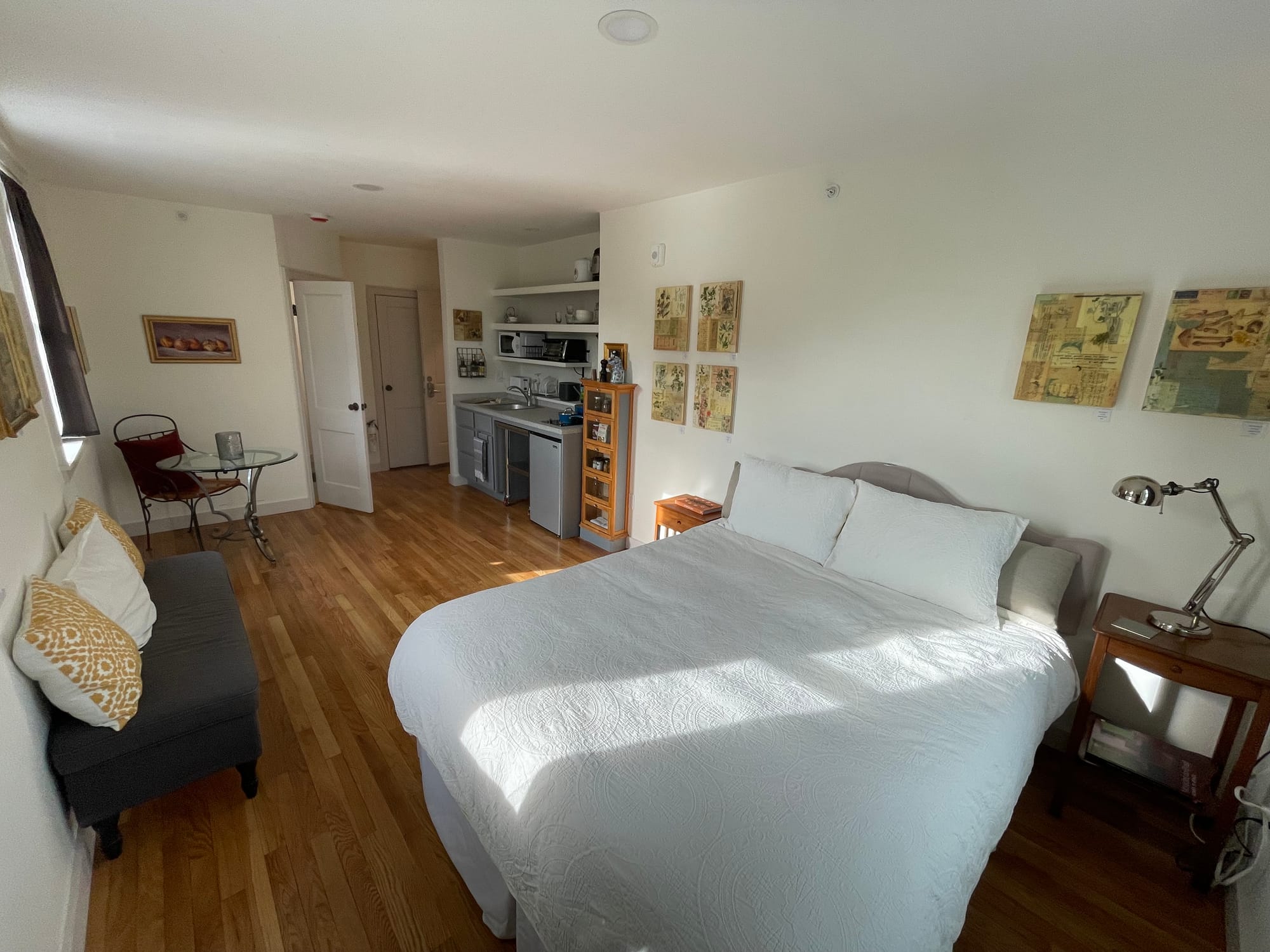 A unit at 141 Westville street with a bed, seat, small table and compact kitchenette.