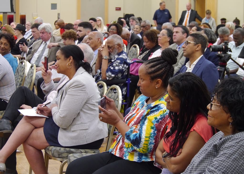Audience members listen as Pires speaks.