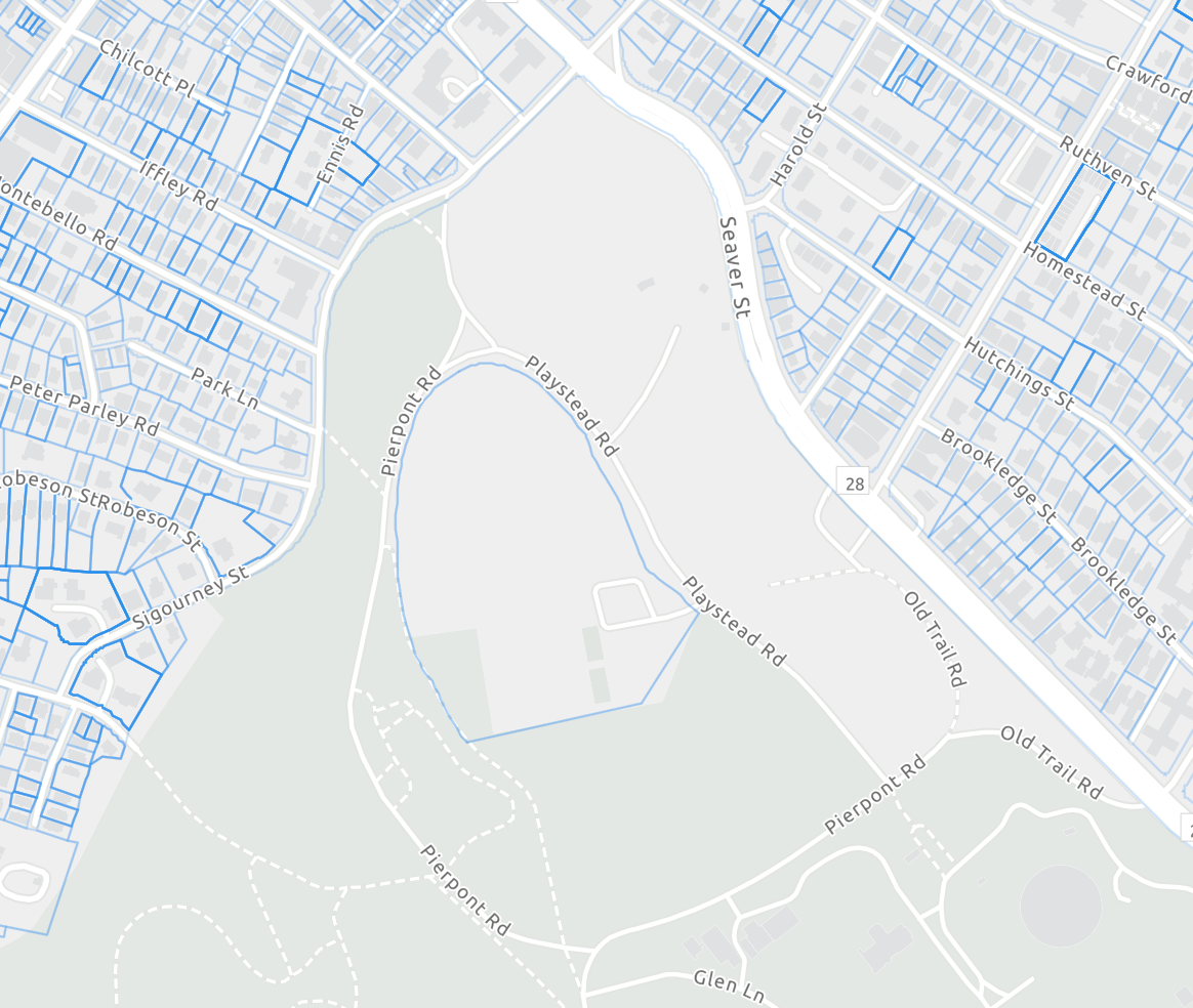 The land owned by Boston Public Schools, shown outlined in blue, is surrounded by park land.